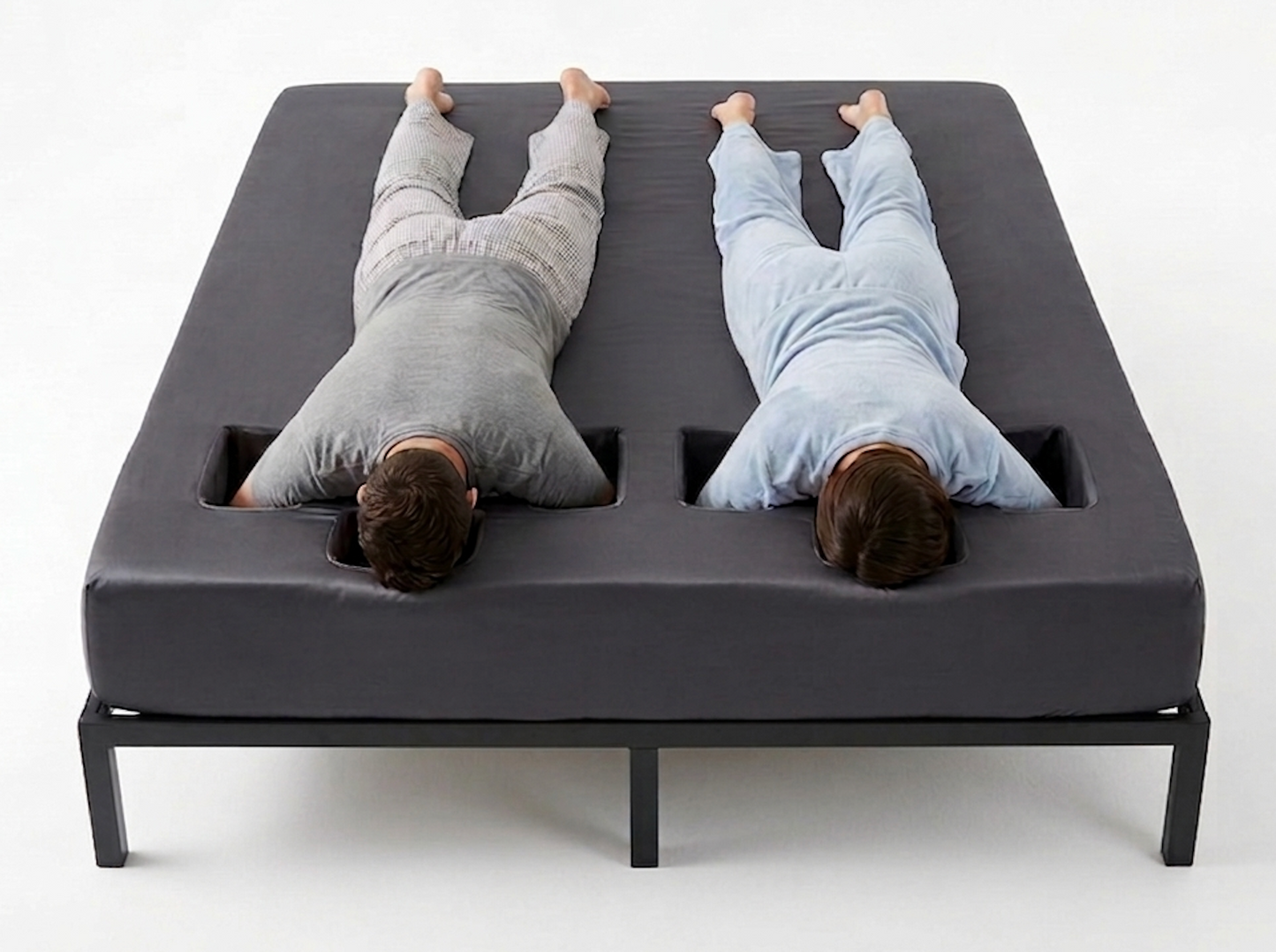 Two people lying on a unique bed design with separate sleeping areas.